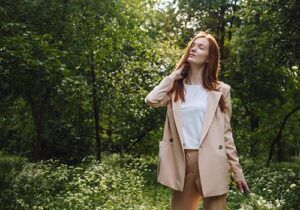 Woman walks in the woods and enjoys scenery after undergoing anxiety therapy in MA