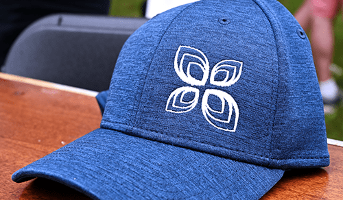 Close-up of a blue baseball cap with logo.