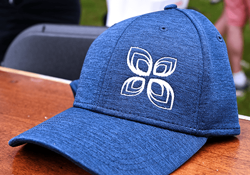 Close-up of a blue baseball cap with logo.