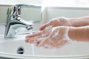 person washes hands and demonstrates ocd behaviors