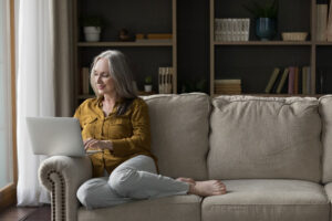 Person sitting on couch and thinking about telehealth for depression