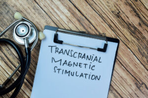 a doctors clipboard says transcranial magentic stimulation