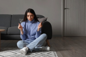 Person sitting on floor and struggling with obsessive-compulsive disorder