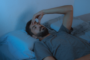 Person wondering about the link between PTSD and sleep