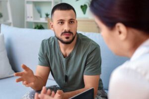 Two people talking about PTSD treatment
