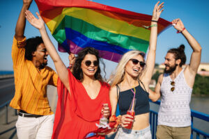 Happy group of friends, people attend a gay pride event
